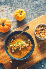 A freshly made pumpkin soup served with croutons