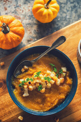 A freshly made pumpkin soup served with croutons