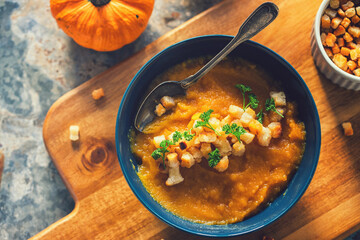 Fresh homemade pumpkin soup served with croutons, top view
