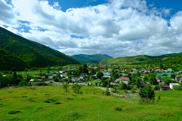Fototapeta na wymiar View of the village of Kolochava Ukraine, among the green mountains. Ukraine Carpathians, Transcarpathia.