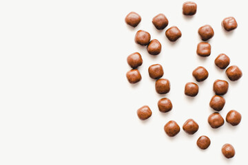 Chocolate dragee on a white background. Chocolate candies. Chocolate on a white background. 