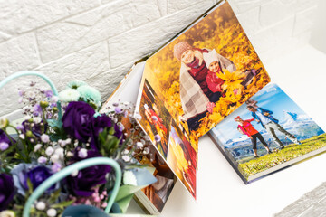 Fototapeta na wymiar purple bouquet on the photobook on a light background