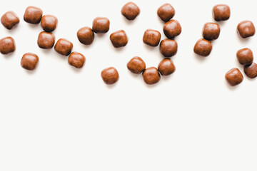 Chocolate dragee on a white background. Chocolate candies. Chocolate on a white background. 