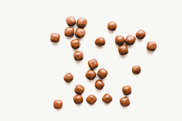 Chocolate dragee on a white background. Chocolate candies. Chocolate on a white background. 