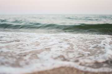 Close up sand with blurred sea sky background, summer day, copy space or for product.
