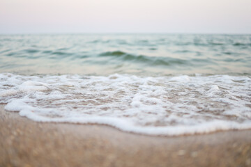 Close up sand with blurred sea sky background, summer day, copy space or for product.