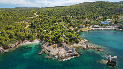 Aerial drone photo of famous bay and small traditional village of Atsitsa covered in pine trees and...