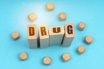 On a blue background, wooden cubes and Jenga with the inscription - DRUG