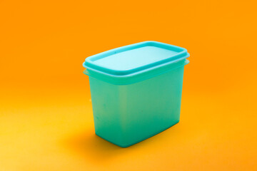 Plastic lunch box (jar or container) isolated on orange background