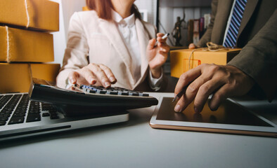 Young woman small business owner online shopping at home. taking note of orders from customers with mobile phones. SME entrepreneur or freelance life style concept.