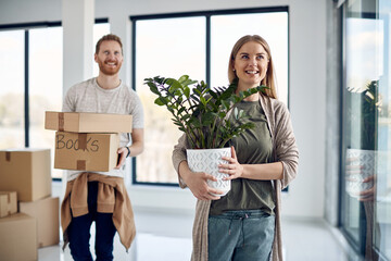 Young happy couple enjoys while moving into new apartment.
