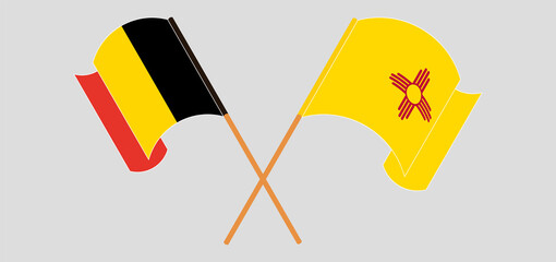 Crossed and waving flags of Belgium and the State of New Mexico