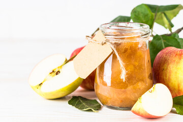 Apple jam with fresh apples on white background.