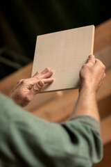 Checking a piece of wood, MDF with wooden veneer material in a woodworking workshop with a designer...