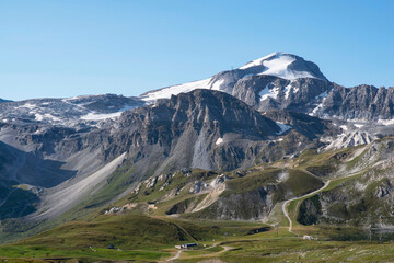 A summer mountain hiker on the summits in front of glaciers
