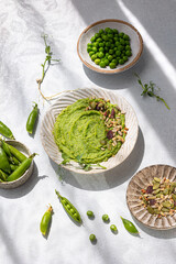 Spicy hummus with green fresh pea shoots. Healthy nutrition. Top view