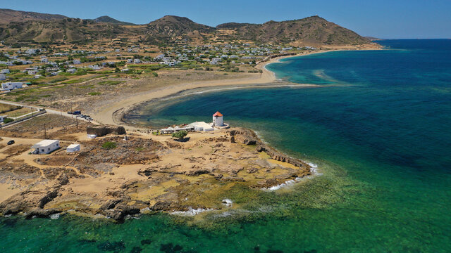 Aerial drone photo of beautiful round sandy bay and traditional windmill in Molos area next to famous church and islet of Agios Ermolaos, Skiros island, Sporades, Greece