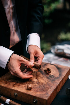 closeup of hands rolling a cigar