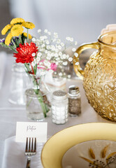 table setting at wedding or dinner party with wildflowers and tea
