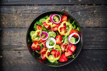 salad vegetables tomato, cucumber, pepper, onion, olive oil healthy food fresh portion veggie ready to eat meal snack on the table copy space food background rustic keto or paleo diet vegan