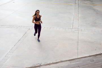 Fototapeta na wymiar Beautiful athlete woman training outdoors. Young fit woman doing exercise outside