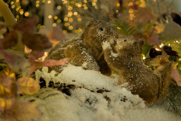 puppet squirrels kiss in a fairy snowy forest. Christmas installation