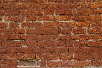 abstract vintage background of an old shabby red brick wall close up