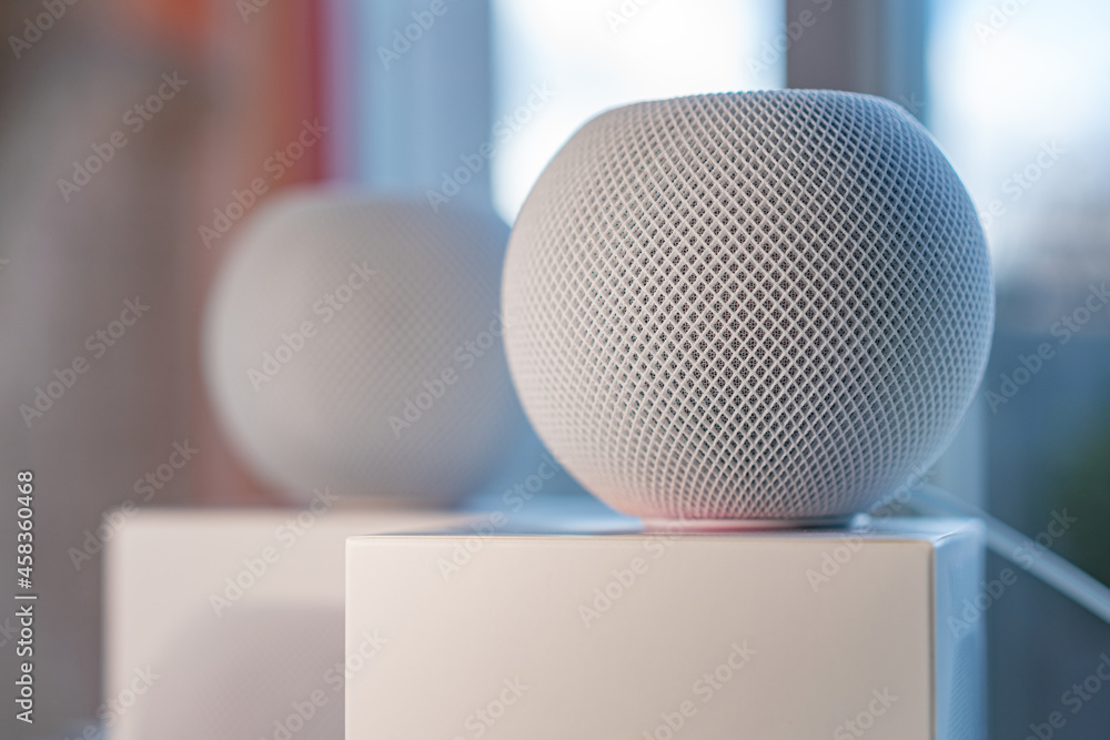 Wall mural Home equipment - close up of smart speaker in foreground and blurred background.