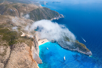 View of Navagio beach, Zakynthos Island, Greece. Aerial landscape. Azure sea water. Rocks and sea. Summer landscape from the air.