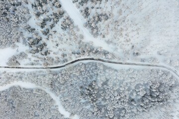Tarmac road running through snowy landscape