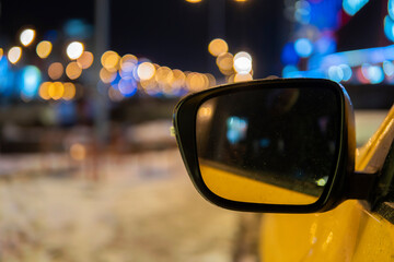 mirror car yellow color on background lights night city.