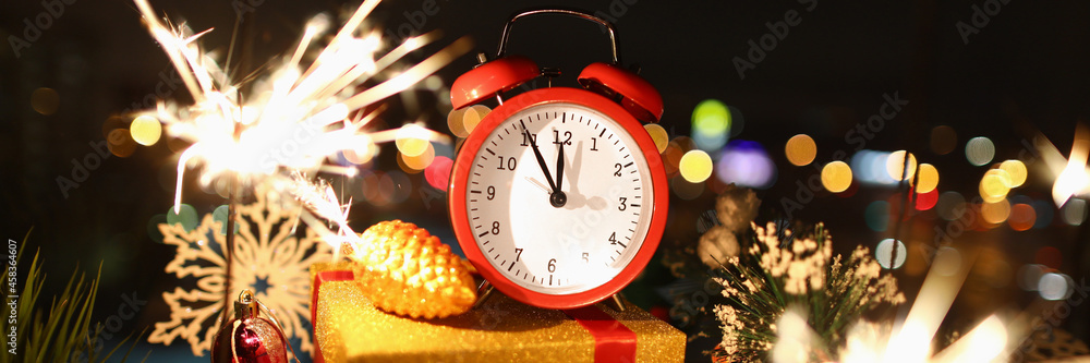 Wall mural Hands on red alarm clock show time of new year's celebration