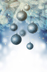 Christmas balls on a blue Christmas tree branch over blurred shiny background. Space for text