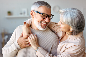 Beautiful smiling senior family couple husband and wife looking at each other with love