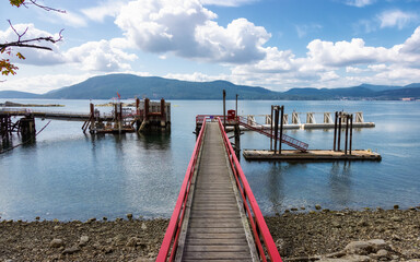 Wooden Pier on the Pacific Ocean West Coast. Sunny Summer Day. Vesuvius Bay, Salt Spring Island, British Columbia, Canada.