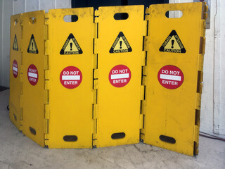 Yellow safety wall elements closing off a public elevator repair site
