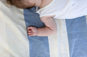 Little cute baby sleeping at the beach