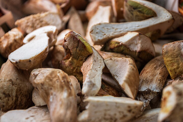 raw porcini mushrooms in a wooden basket, shallow depth of field
