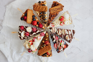 Appetizing tasty cheesecake with fruits on sticks