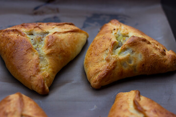 Triangles - echpochmaki fresh from the oven on a baking sheet