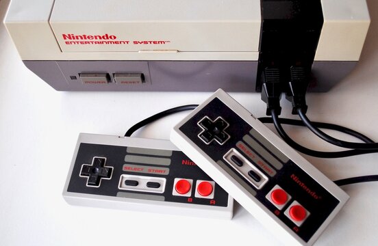 The Nintendo Entertainment System (NES), an 8-bit third-generation home video game console produced by Nintendo. NES Control Deck home video game console with controllers.