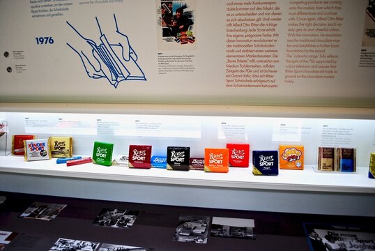 Waldenbuch, Germany: Ritter Sport chocolate museum, ChocoExhibition and visitor center. Brightly lit display shows the history of the iconic wrapper including the knick-pack (snap package).