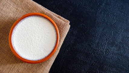 fresh natural turkish yogurt with black stone background