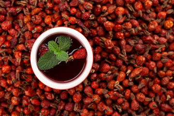 Vitamin tea or tincture from dried rosehip berries. Antioxidant, a tasty and healthy source of vitamin C. It is used in alternative therapies. Top view, Selective focus