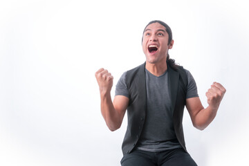 Person with white background, man making gestures, he is happy for a victory and with clenched fists he celebrates, looking up he is very happy because he won something