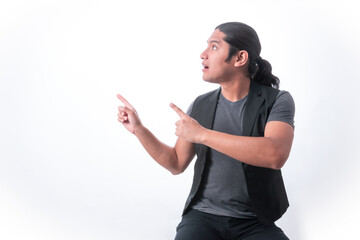 Person with white background, man gesturing, he points with both hands up showing the white area, blank space