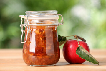 Delicious apple jam and fresh fruit on wooden table