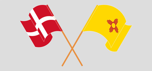 Crossed and waving flags of Denmark and the State of New Mexico