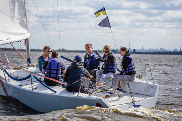 Team athletes participating in the sailing competition.Sailing Crew in Action.Young people enjoying on the yacht