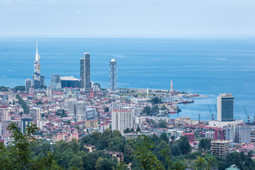 ariel panoramic view of old city and skyscrapers with the sea from the mountains